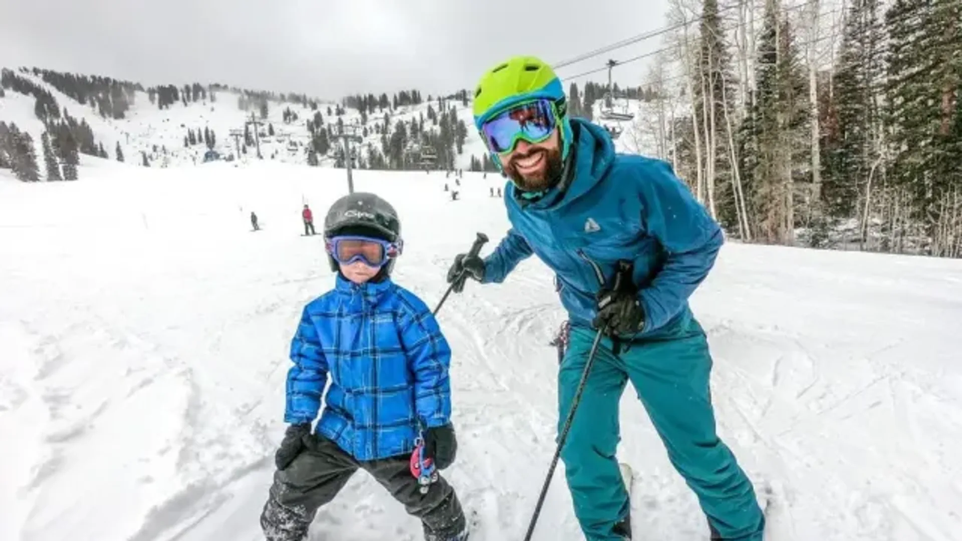 A parent and child in ski kit on a snowy slope — Papa Sports mood